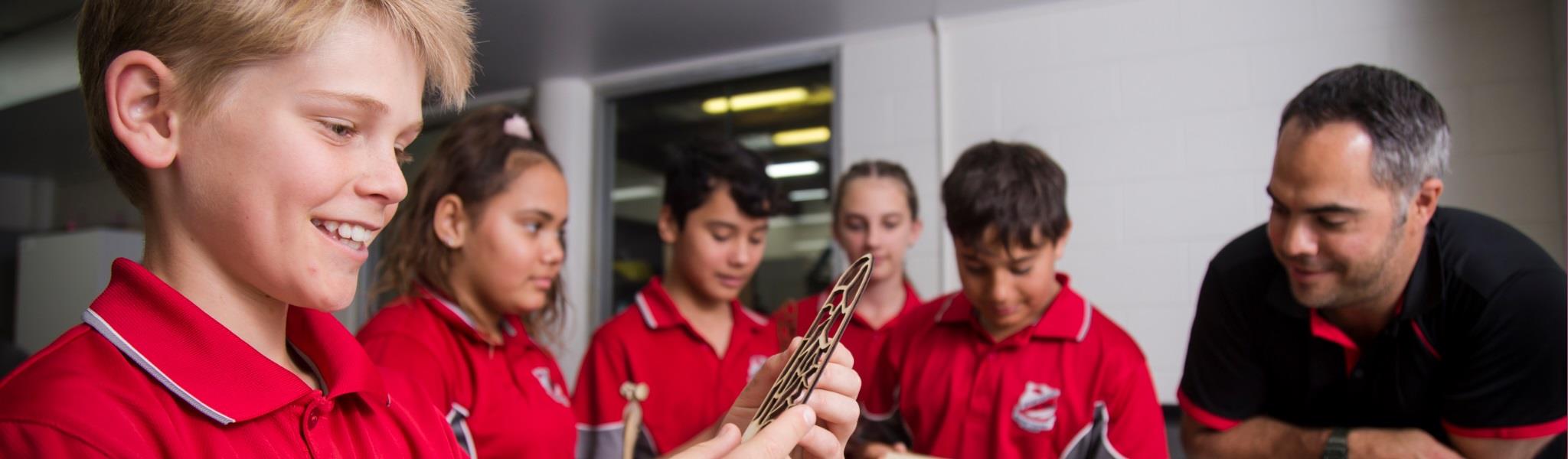 Students learning from a teacher in a classroom